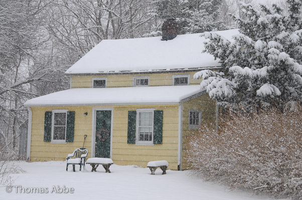 Yellow Cottage in Falling Snow